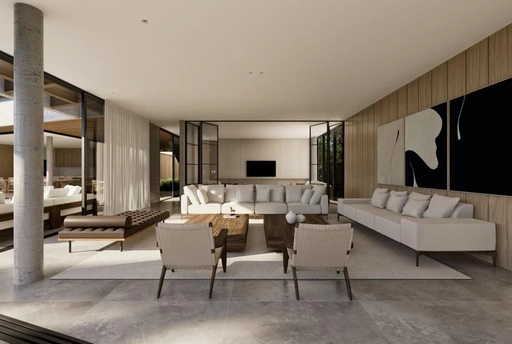 Open-concept living room with white sectional sofas, two woven armchairs, and wooden coffee tables in a sunlit modern home.