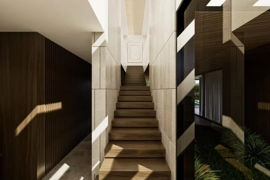 Wooden staircase rising between light stone walls in a modern interior, with dramatic diagonal shadows.